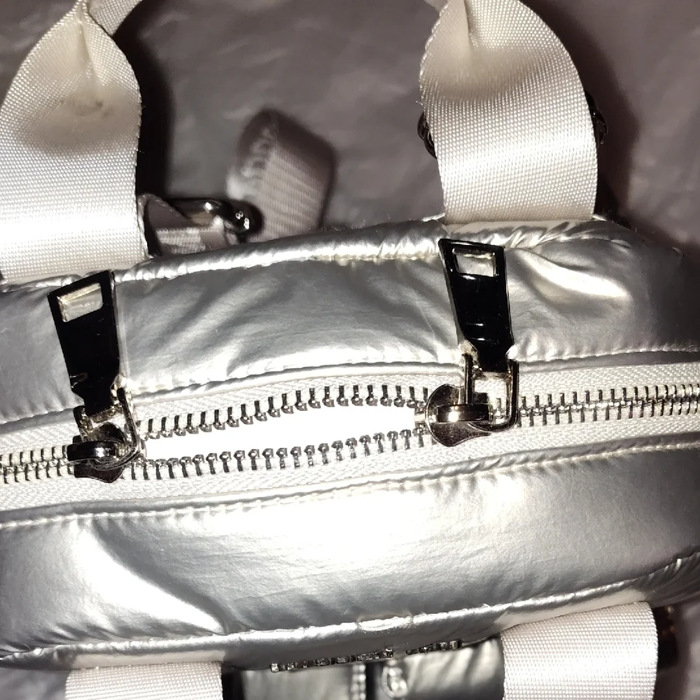 Steve Madden Silver Backpack. Front and side pockets.